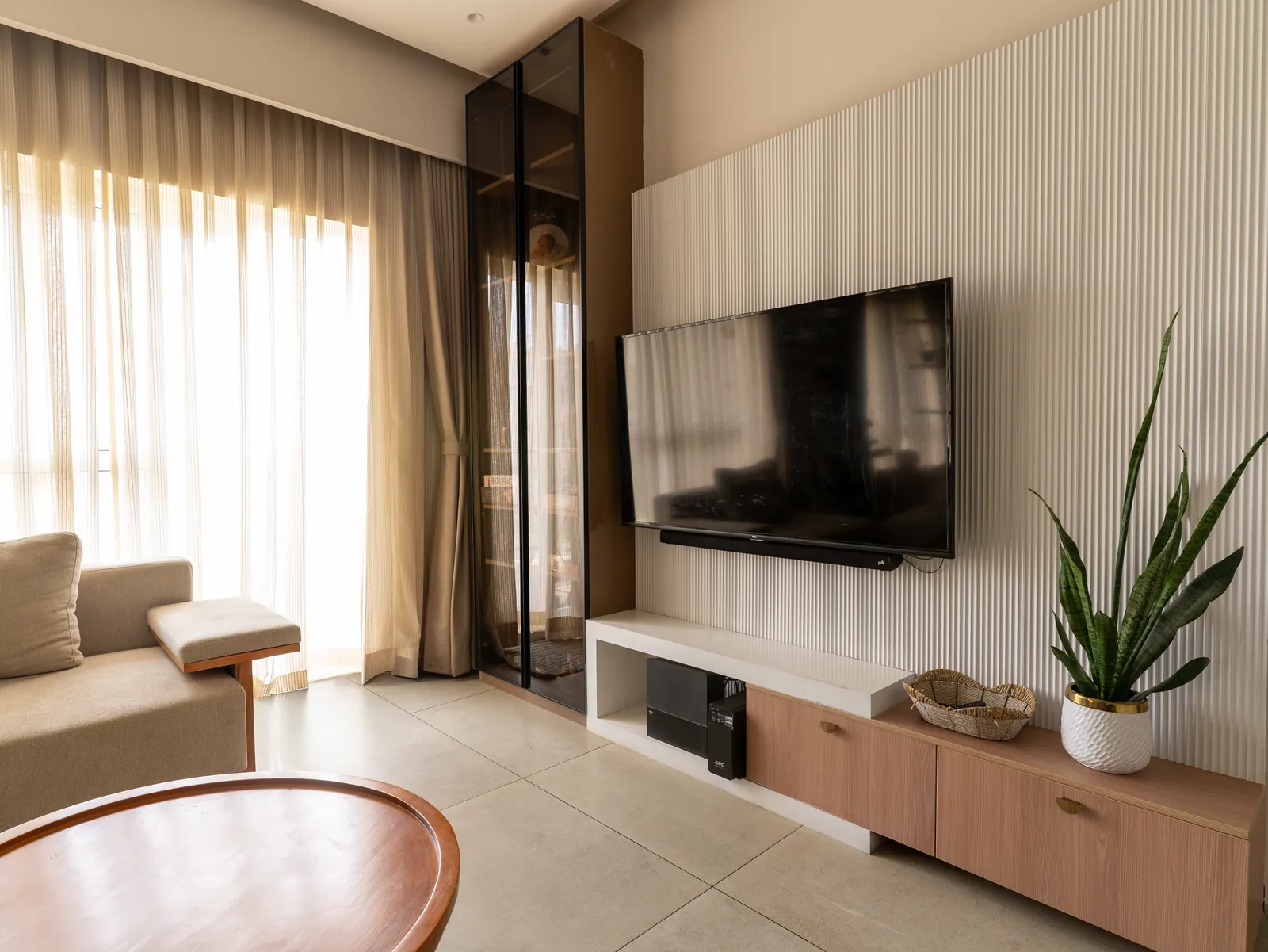 Fluted TV wall with oak-and-white console — Amlan's Residence